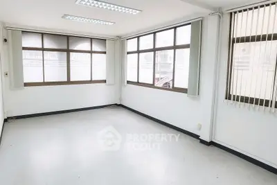 Spacious office space with large windows and ample natural light.