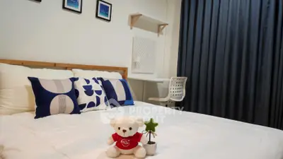 Cozy bedroom with stylish decor and plush bedding