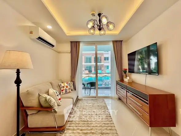 Stylish living room with modern decor and pool view balcony access.