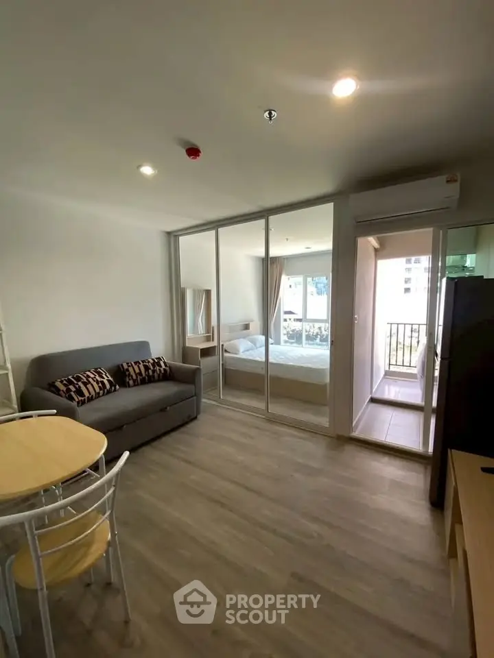 Modern open-plan living room with glass partition and balcony view