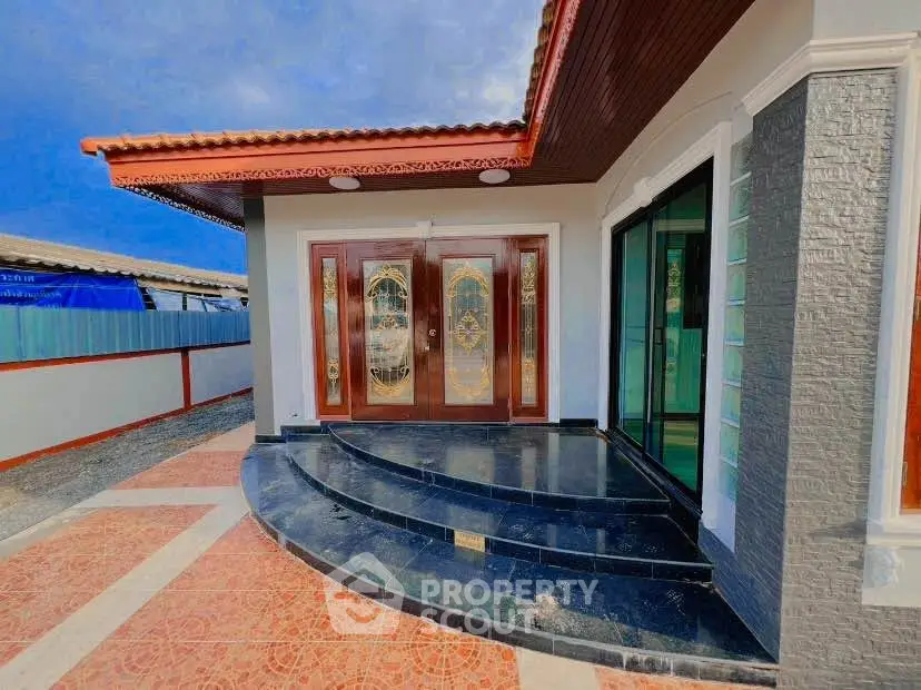 Elegant modern house entrance with stylish double doors and sleek tiled steps.