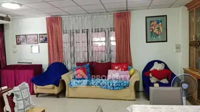Cozy living room with colorful sofas and decorative pillows, perfect for family gatherings.