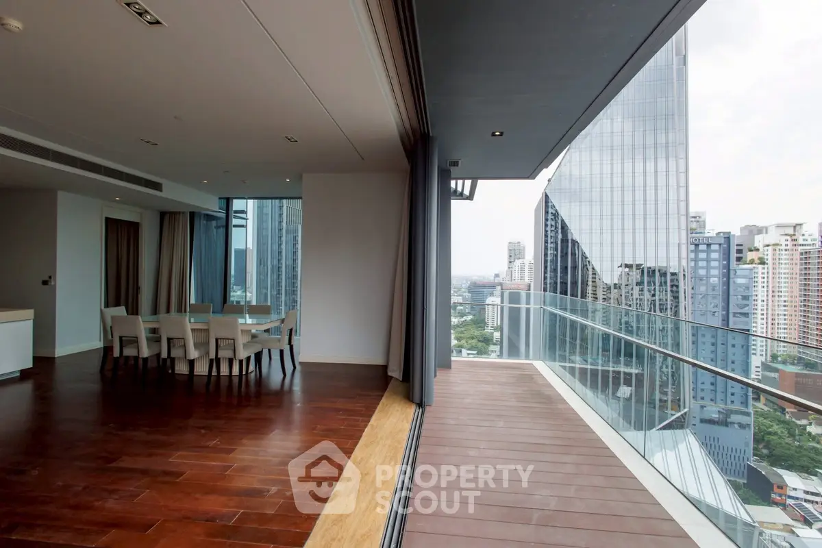 Luxurious high-rise apartment with spacious balcony and stunning city view.