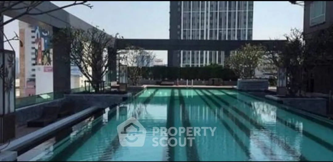 Luxurious rooftop pool with stunning cityscape views in modern high-rise building.