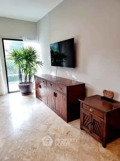 Elegant living room with modern TV setup and stylish wooden furniture