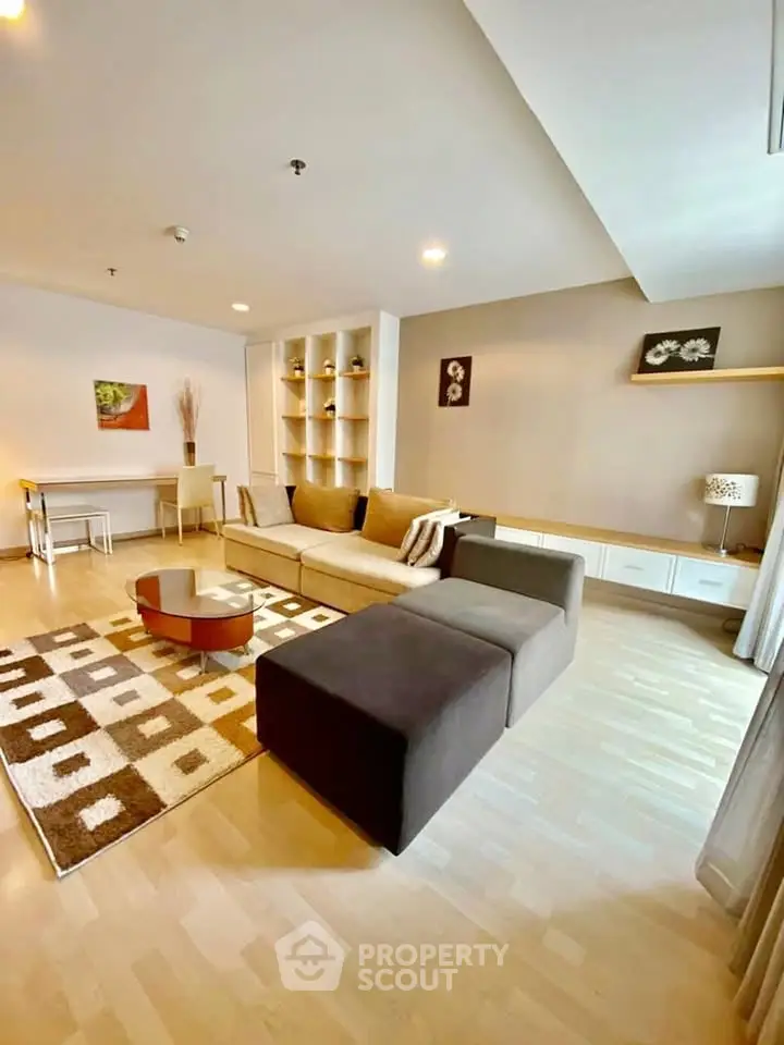 Spacious modern living room with stylish decor and ample natural light.