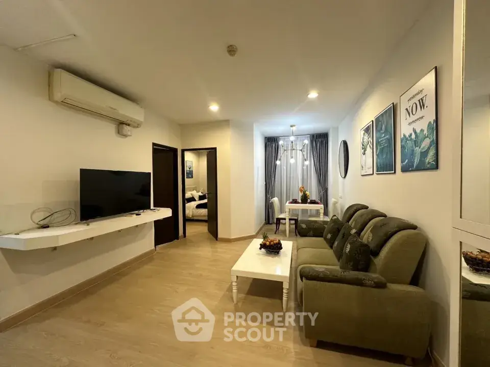Spacious living room with modern decor and cozy seating area in a stylish apartment.