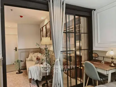 Charming living room with elegant decor and cozy workspace in modern apartment.
