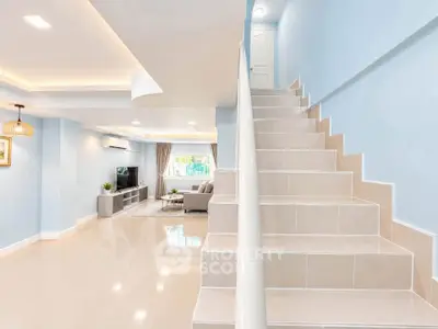 Spacious modern living room with elegant staircase and stylish decor