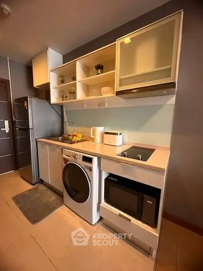 Modern kitchen with sleek appliances and ample storage in a compact layout.
