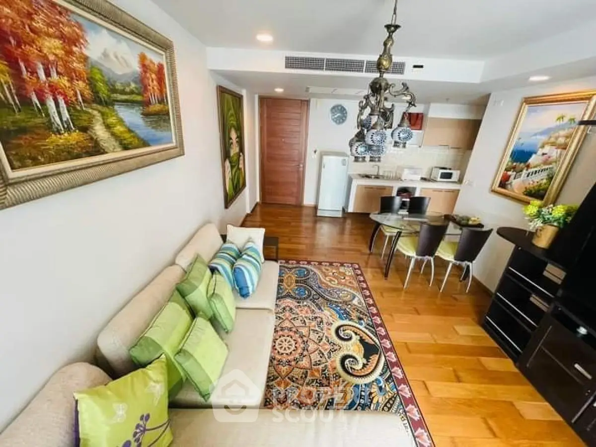 Charming living room with open kitchen, elegant decor, and vibrant artwork, perfect for modern living.