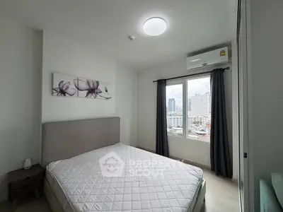 Modern bedroom with city view, featuring a cozy bed and elegant decor.