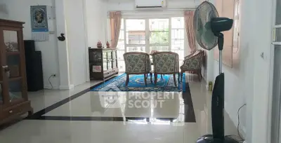 Spacious living room with elegant furniture and large windows for natural light.