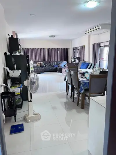Spacious living room with modern furniture and large windows in a stylish home.