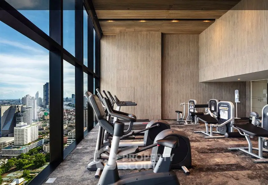Luxurious high-rise gym with panoramic city views and modern fitness equipment.