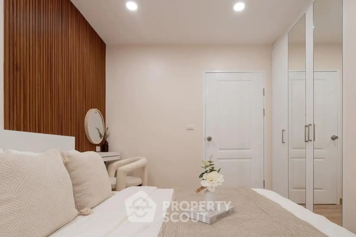 Cozy bedroom with elegant decor and mirrored closet doors