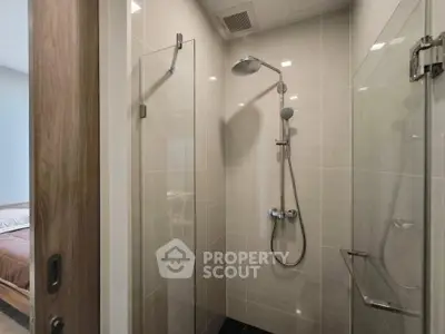 Modern bathroom with sleek shower design and glass door in a contemporary home.