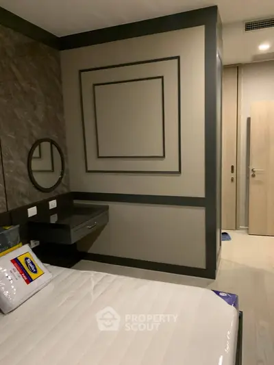 Modern bedroom with stylish wall decor and sleek furniture