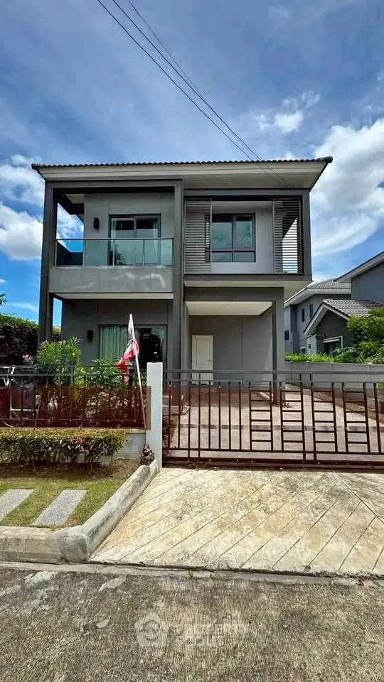 Modern two-story house with sleek design and spacious driveway in a suburban neighborhood.