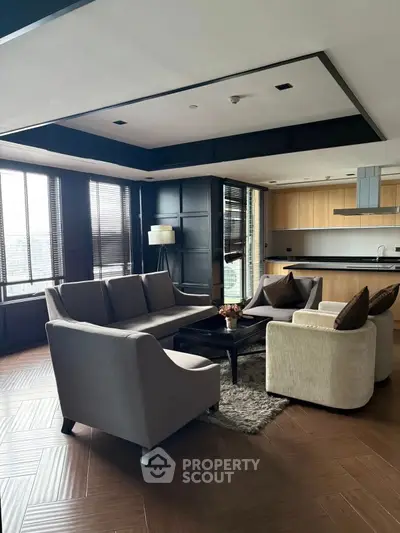 Luxurious modern living room with open kitchen and elegant furnishings.