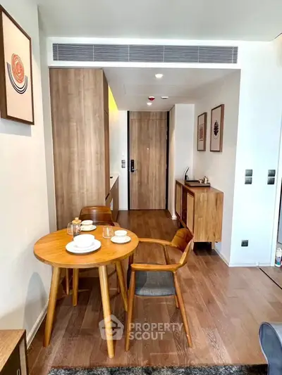 Modern apartment interior with stylish dining area and wooden furniture, showcasing contemporary design and cozy ambiance.