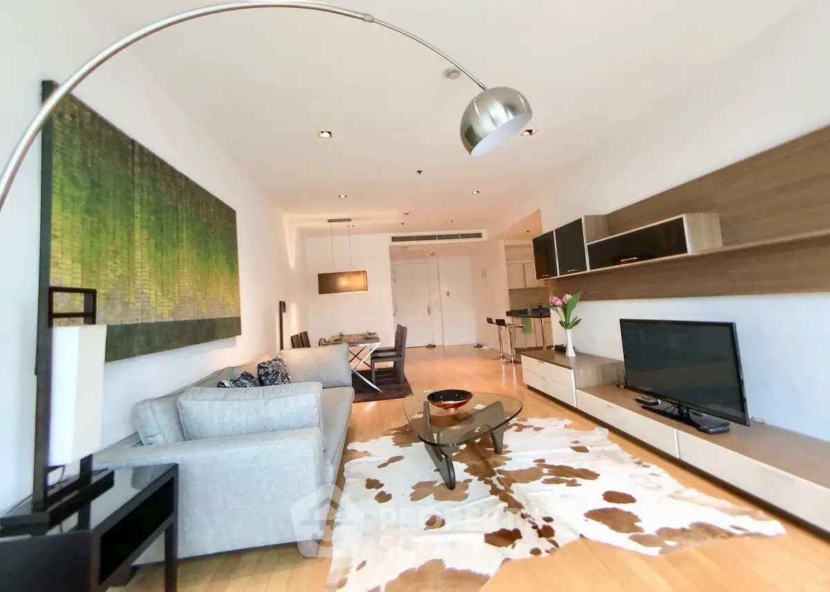 Spacious modern living room with stylish decor and open layout, featuring a cozy seating area and contemporary furnishings.