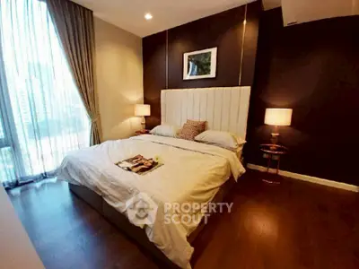 Luxurious bedroom with elegant decor and large window offering city views.