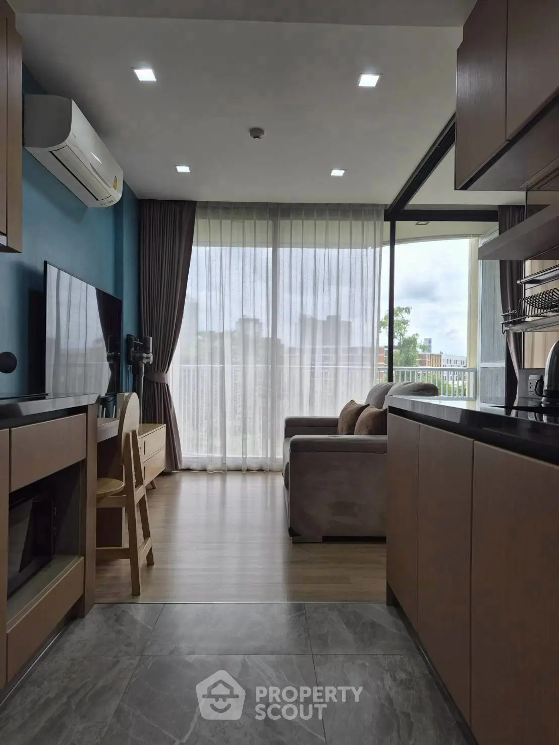 Modern open-layout living room with large windows and stylish furnishings