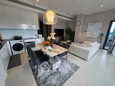 Modern open-layout living room with kitchen, dining area, and stylish decor