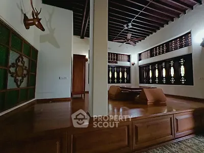 Elegant living room with traditional wooden decor and unique architectural details.