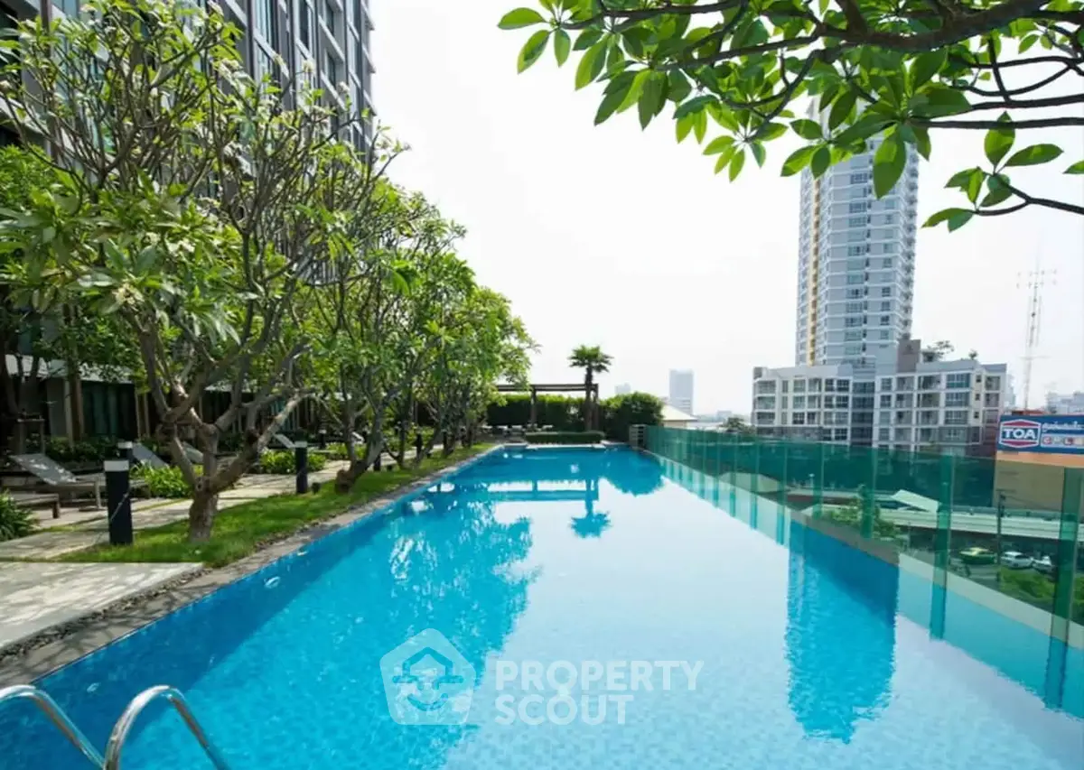 Luxurious high-rise apartment with stunning rooftop pool and city views.