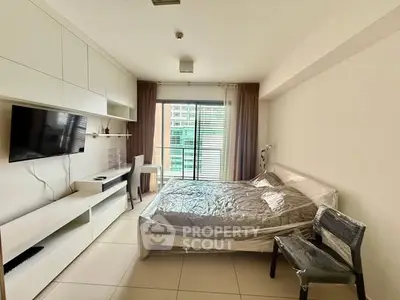 Modern bedroom with sleek built-in storage and large window view.