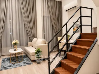 Modern duplex living room with elegant decor and staircase