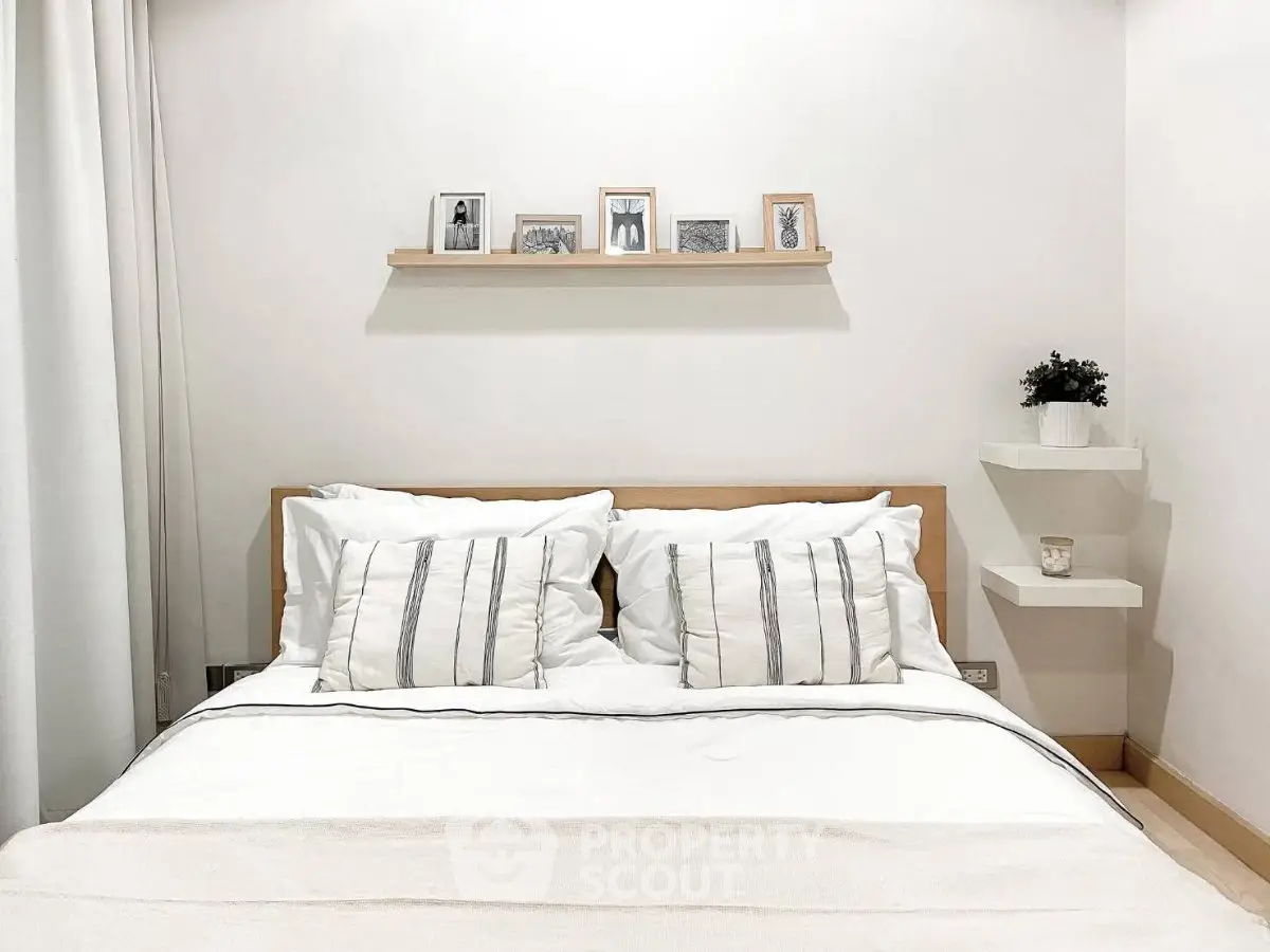 Cozy minimalist bedroom with stylish decor and comfortable bedding, perfect for relaxation.