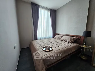 Cozy bedroom with elegant decor and natural light, perfect for relaxation.