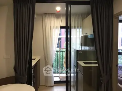 Modern apartment kitchen with balcony view and sleek appliances