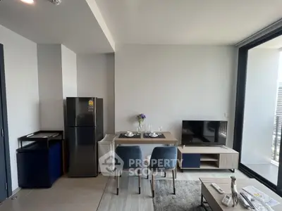 Modern living room with sleek furniture and large window offering natural light