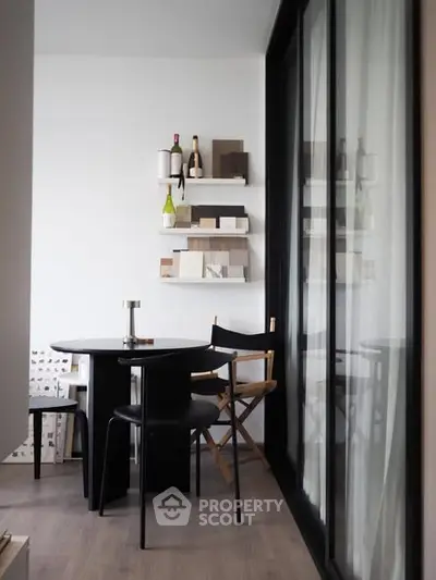 Chic modern dining area with stylish decor and floor-to-ceiling windows.