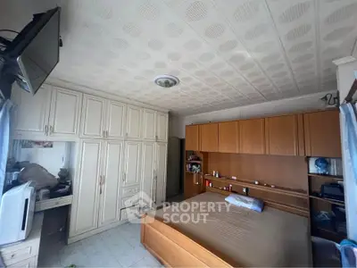 Spacious bedroom with built-in wardrobes and cozy decor