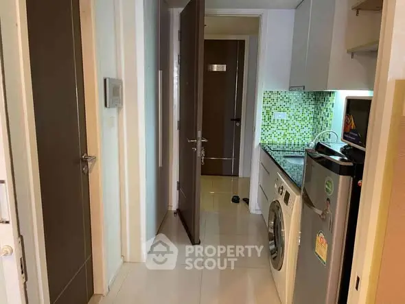 Modern apartment hallway with washing machine and stylish backsplash