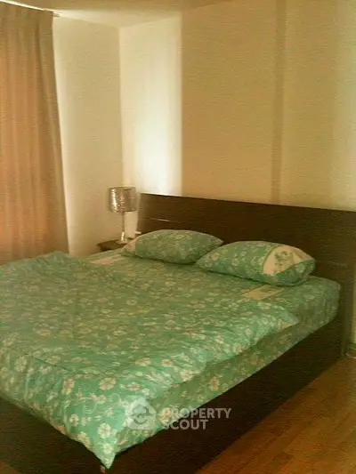 Cozy bedroom with double bed and elegant decor in modern apartment.