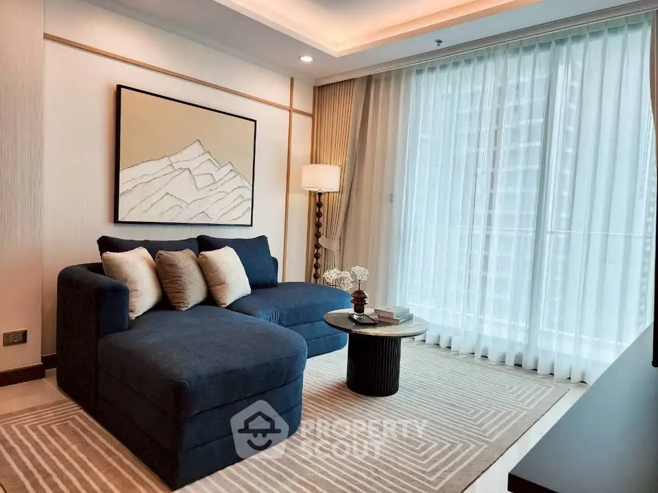 Elegant living room with modern decor and large window, featuring a stylish sofa and chic artwork.