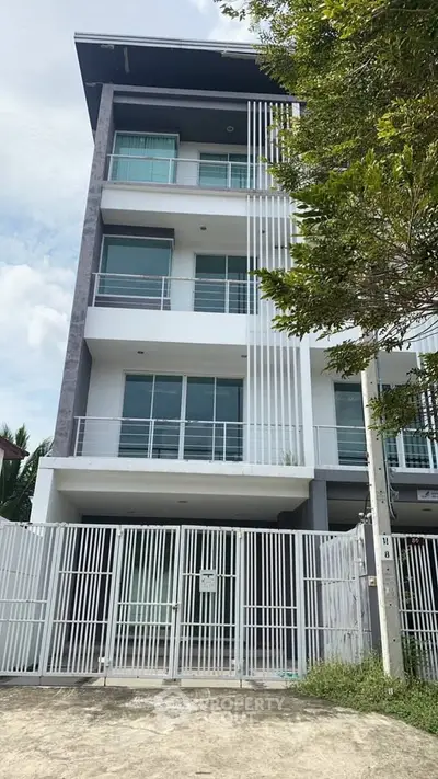 Modern multi-story building with sleek design and spacious balconies