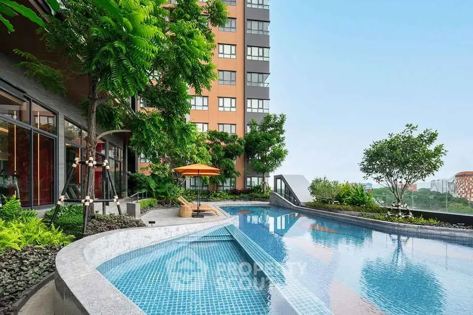 Luxurious apartment building with stunning pool and lush greenery, offering a serene urban oasis.