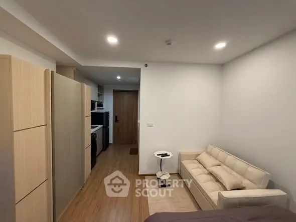Modern studio apartment with cozy living area and compact kitchen