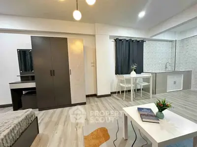 Modern studio apartment with stylish decor, featuring a cozy living area, compact kitchen, and elegant furnishings.
