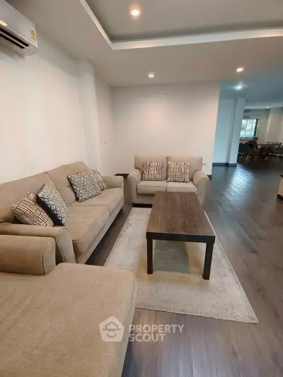 Spacious living room with modern furniture and elegant wooden flooring
