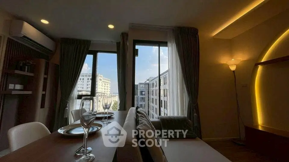 Modern living room with elegant decor and city view from large windows