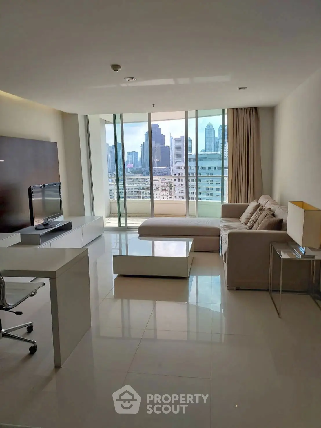 Modern living room with city view, sleek furniture, and natural light.