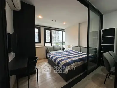 Modern bedroom with large windows and stylish decor in urban apartment